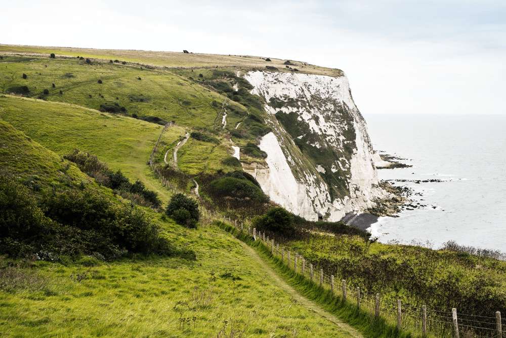 Public footpath on a large field next to the edge of the White Cliffs.